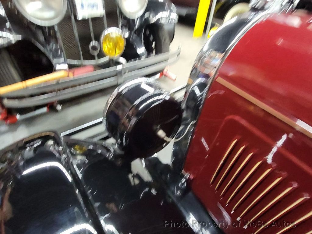 Car Under Hood Close Up, View Of A Red Engine With Big Black Round